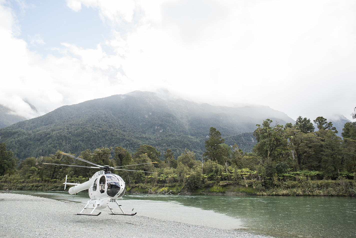 Helicopter taking off from next to river