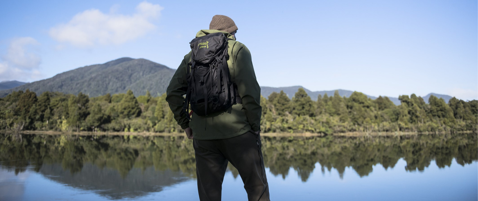 Man overlooking lake with reflections