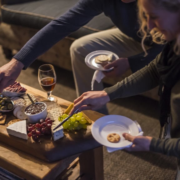 Guests sharing platter with drinks